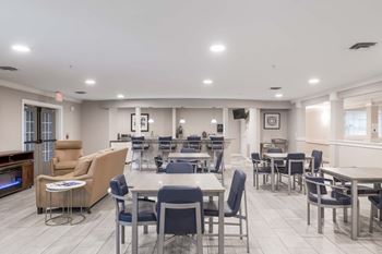A spacious dining area with tables and chairs.